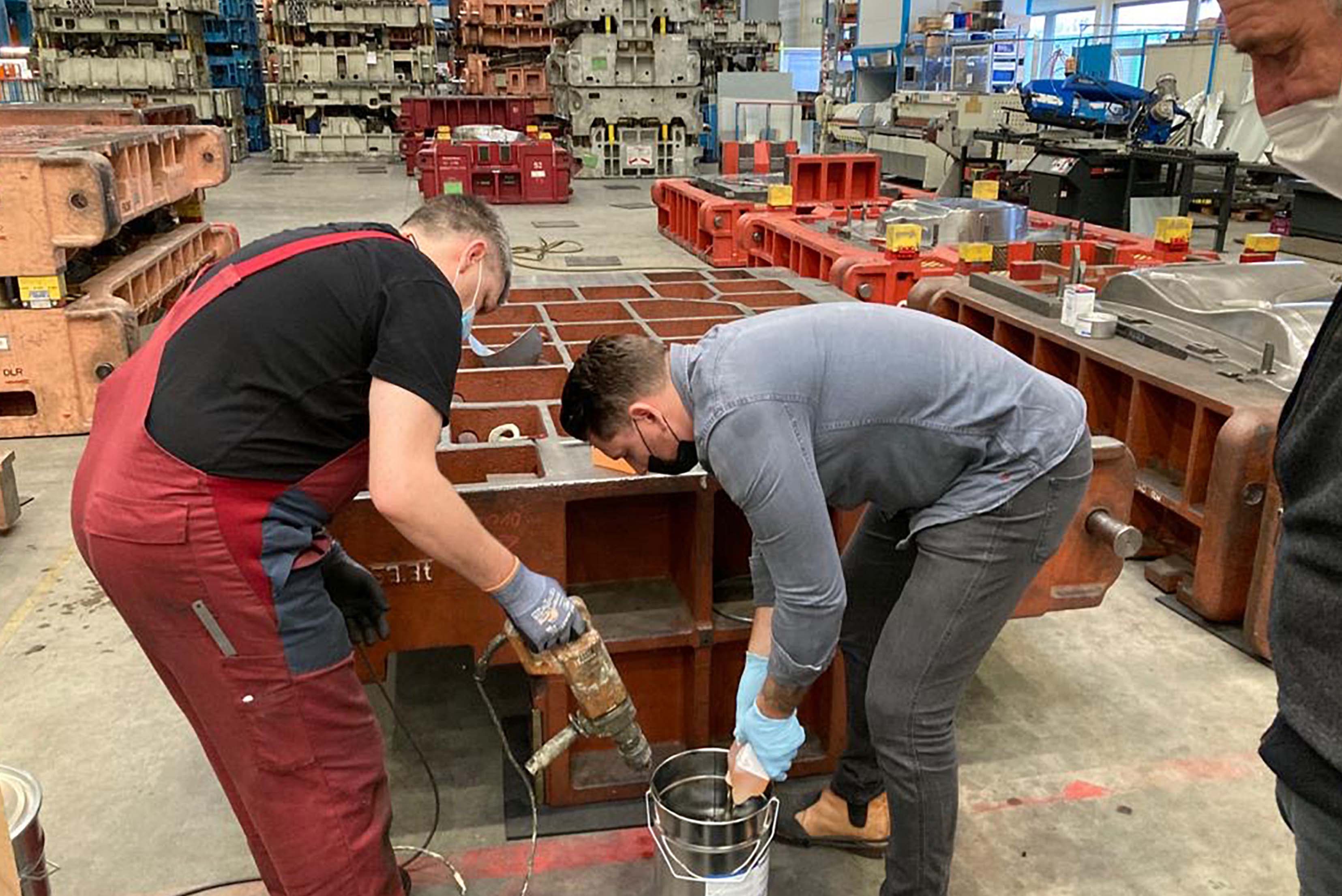 Zwei Männer Mischen etwas mit einem Bohrer